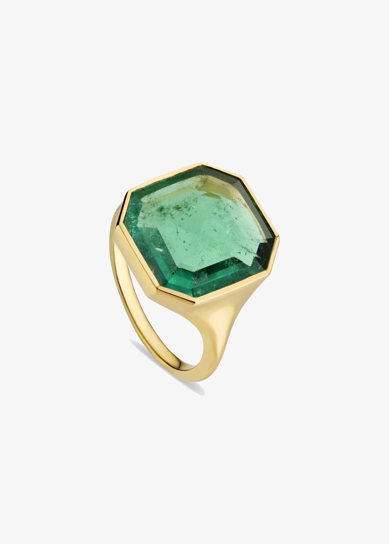 Woman wearing a green gemstone ring on her finger.