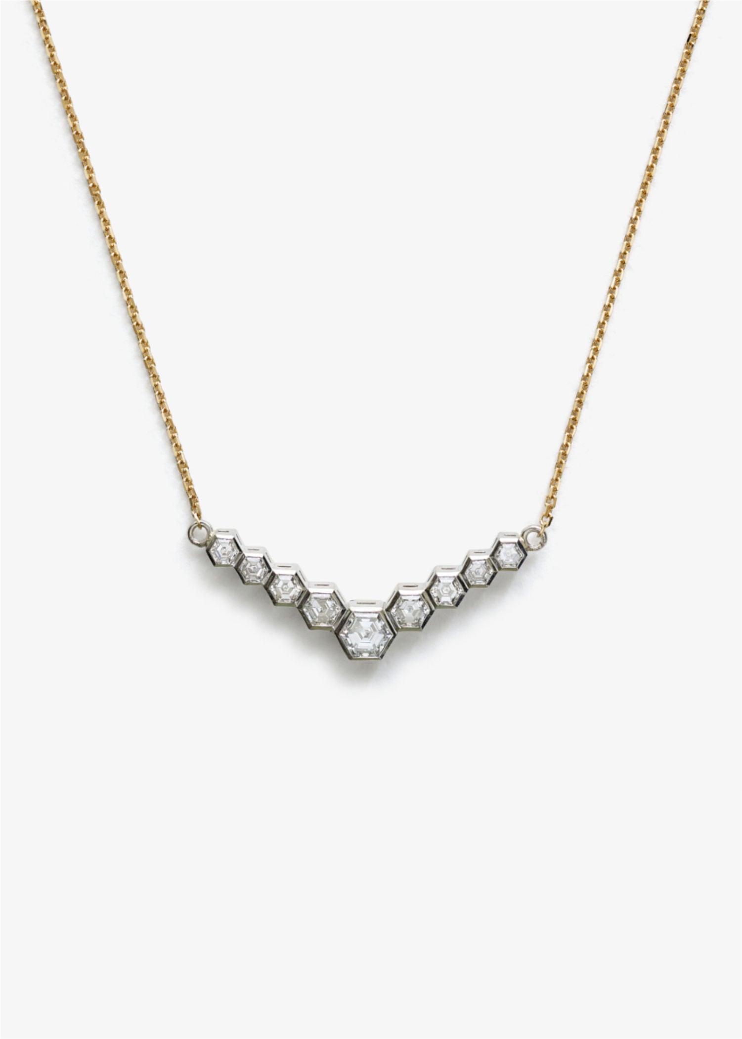 Gold hexagon diamond necklace shown on white background for product display.