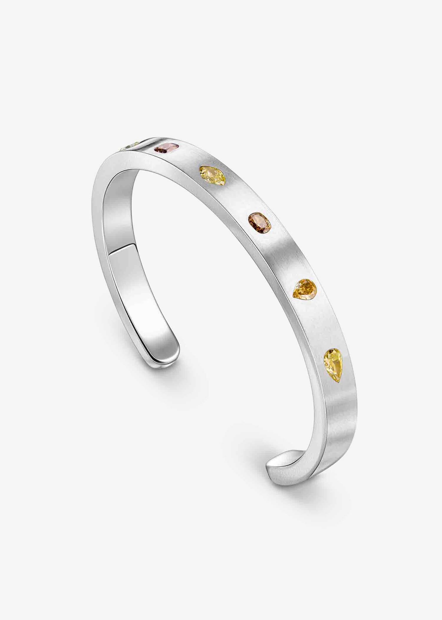 Platinum cuff bracelet with mixed fancy-cut diamonds on matte textured surface.