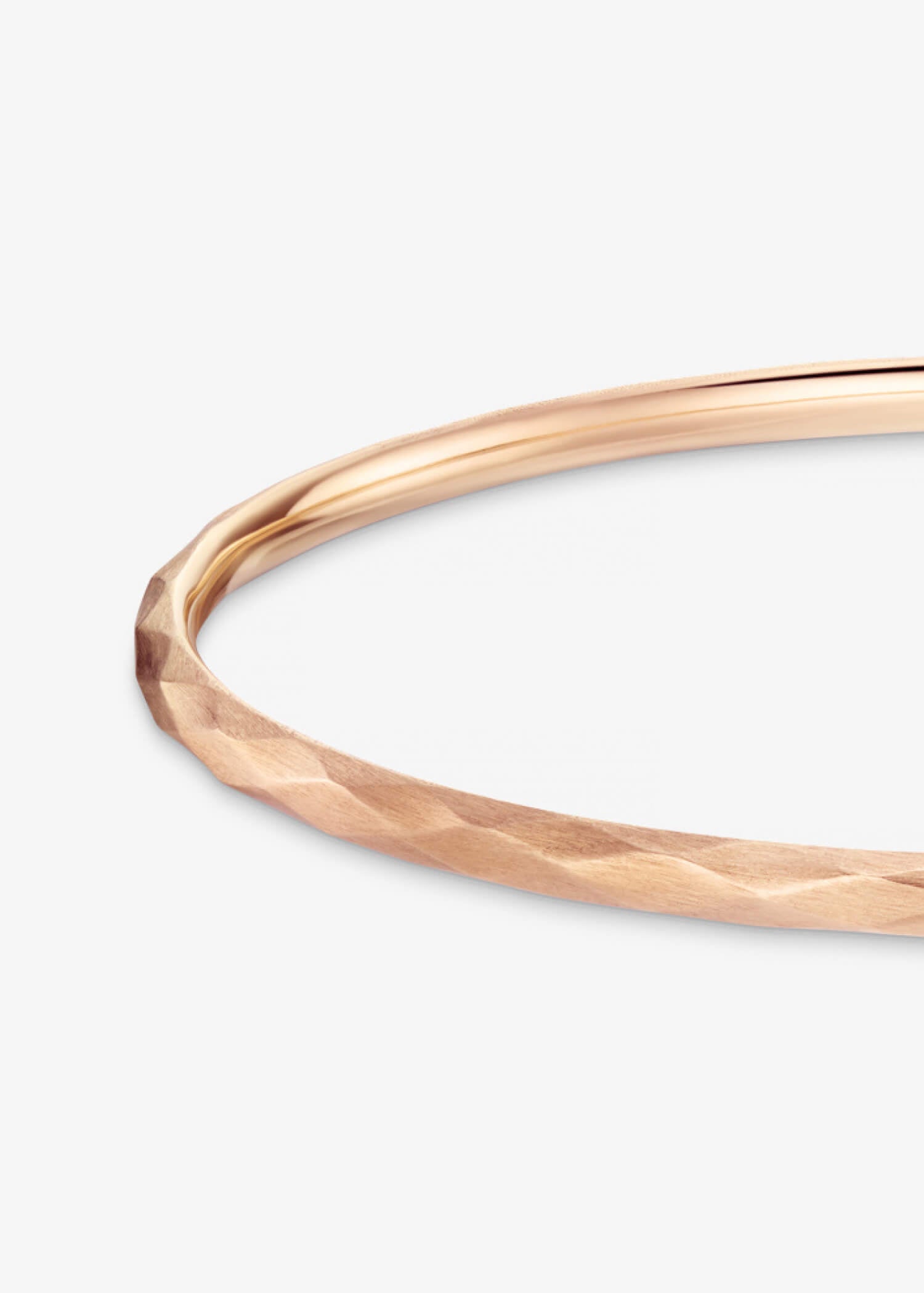 18k rose gold bangle bracelet with a sleek minimalist profile.