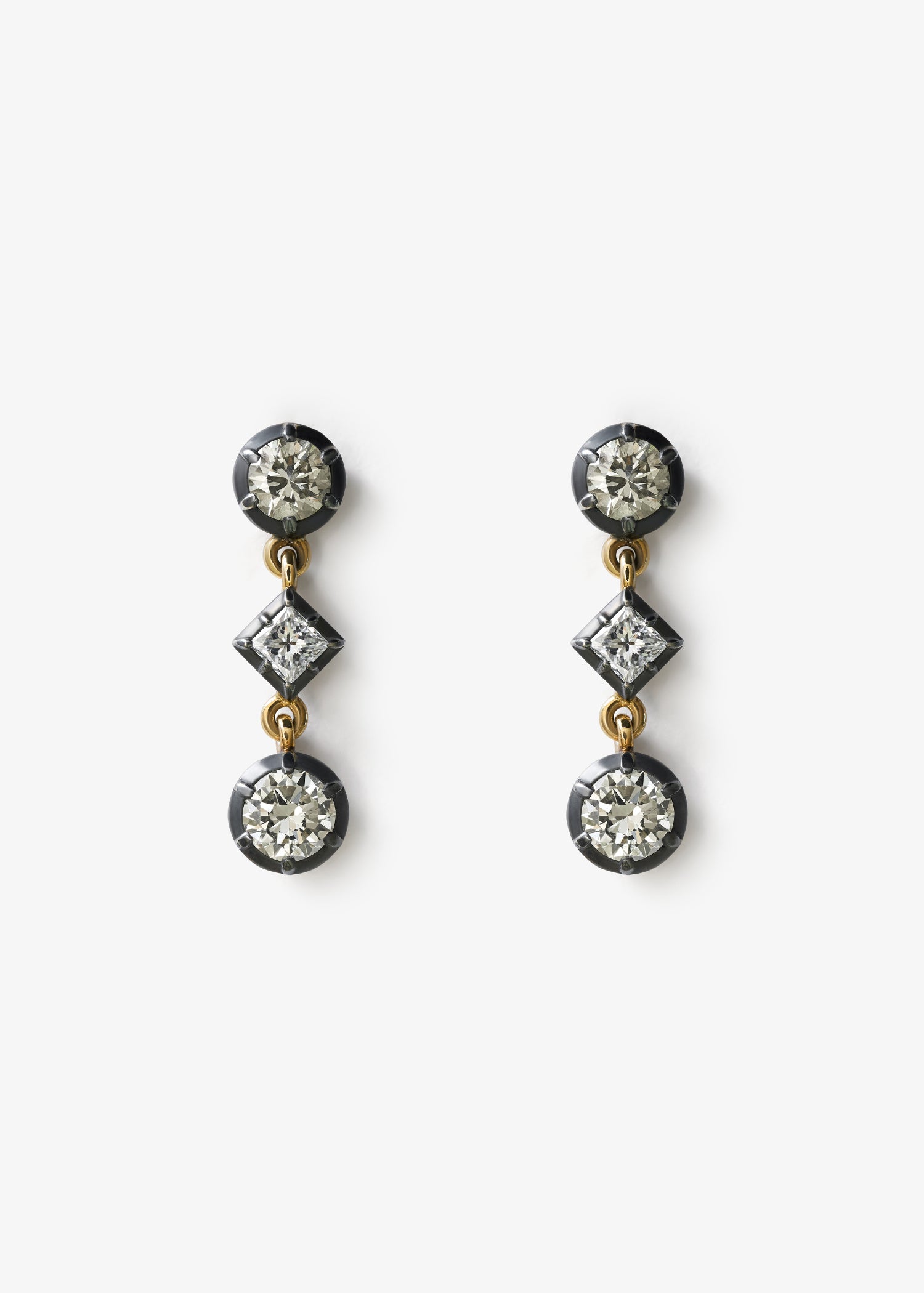 Diamond Drop Earrings with delicate dangling diamonds in a minimalist fine jewelry style.