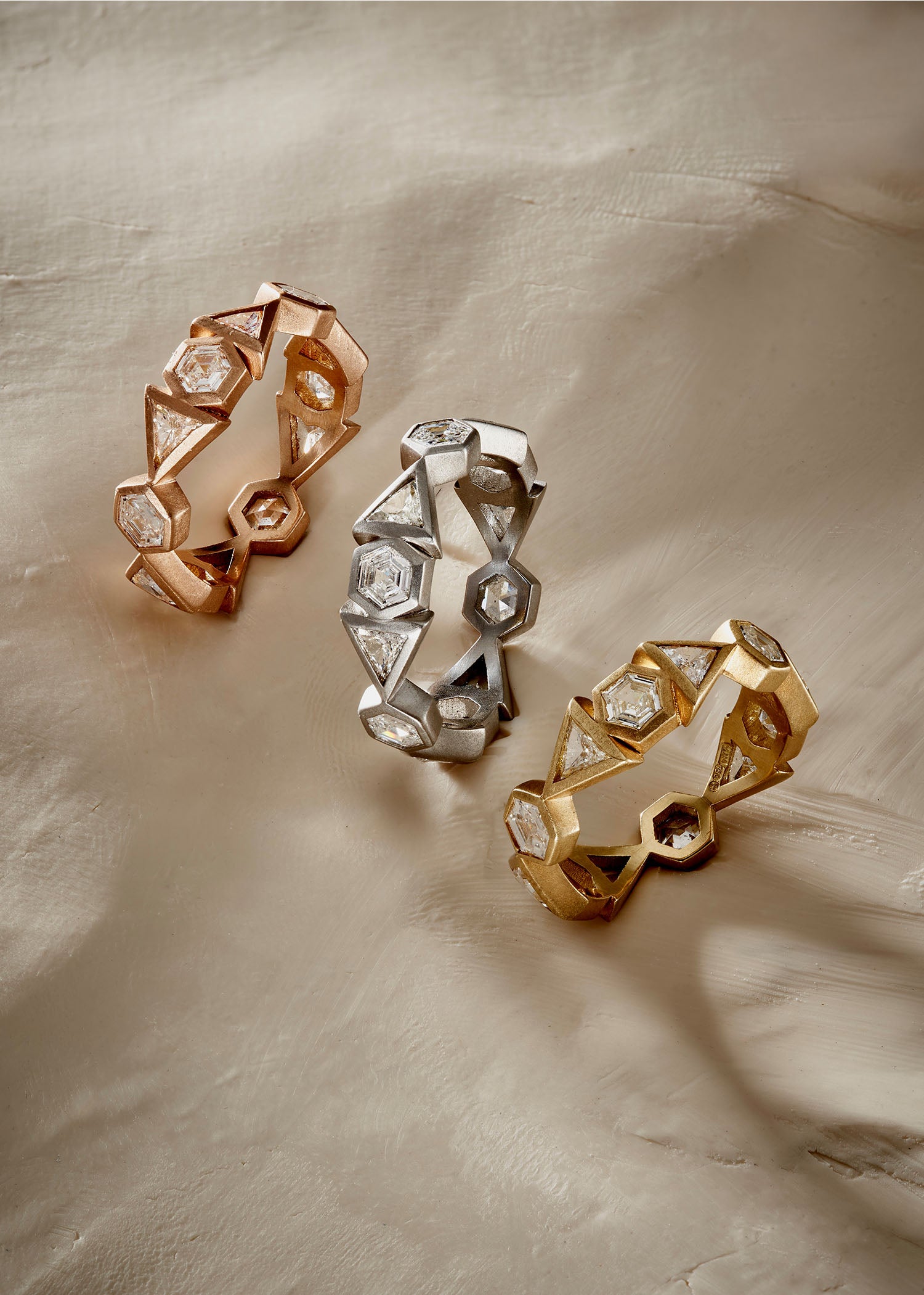 18k rose gold diamond crown ring with hexagonal and triangular stone settings.