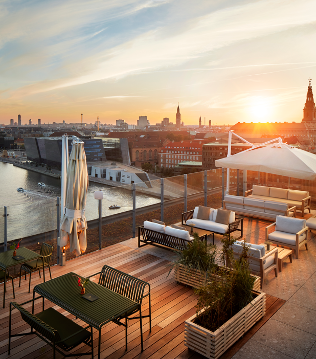 Close-up of three gourmet appetizers with cream, chives, and black caviar on toasted bread rounds.