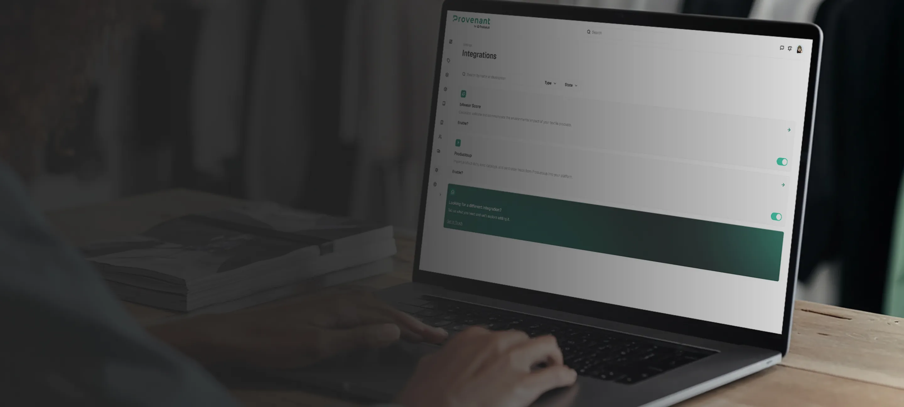 Person typing on a laptop displaying a software integrations settings page with toggles enabled.