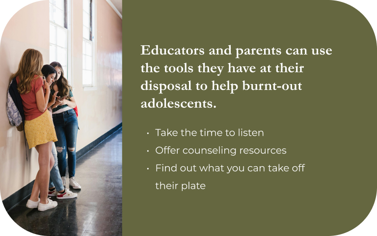Image: Three teen girls standing and looking at their phones in a school hallway. Text: Educators and parents can use the tools they have at their disposal to help burnt-out adolescents. Take time to listen, offer counseling resources, and find out what you can take off their plate.p