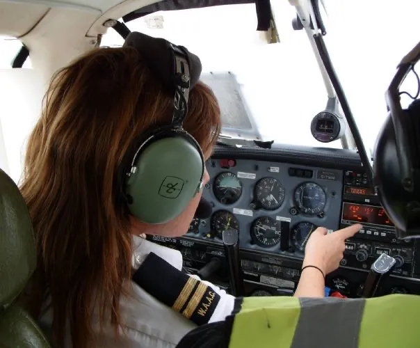 Rachel Gardner-Poole OBE in the cockpit of an aircraft.