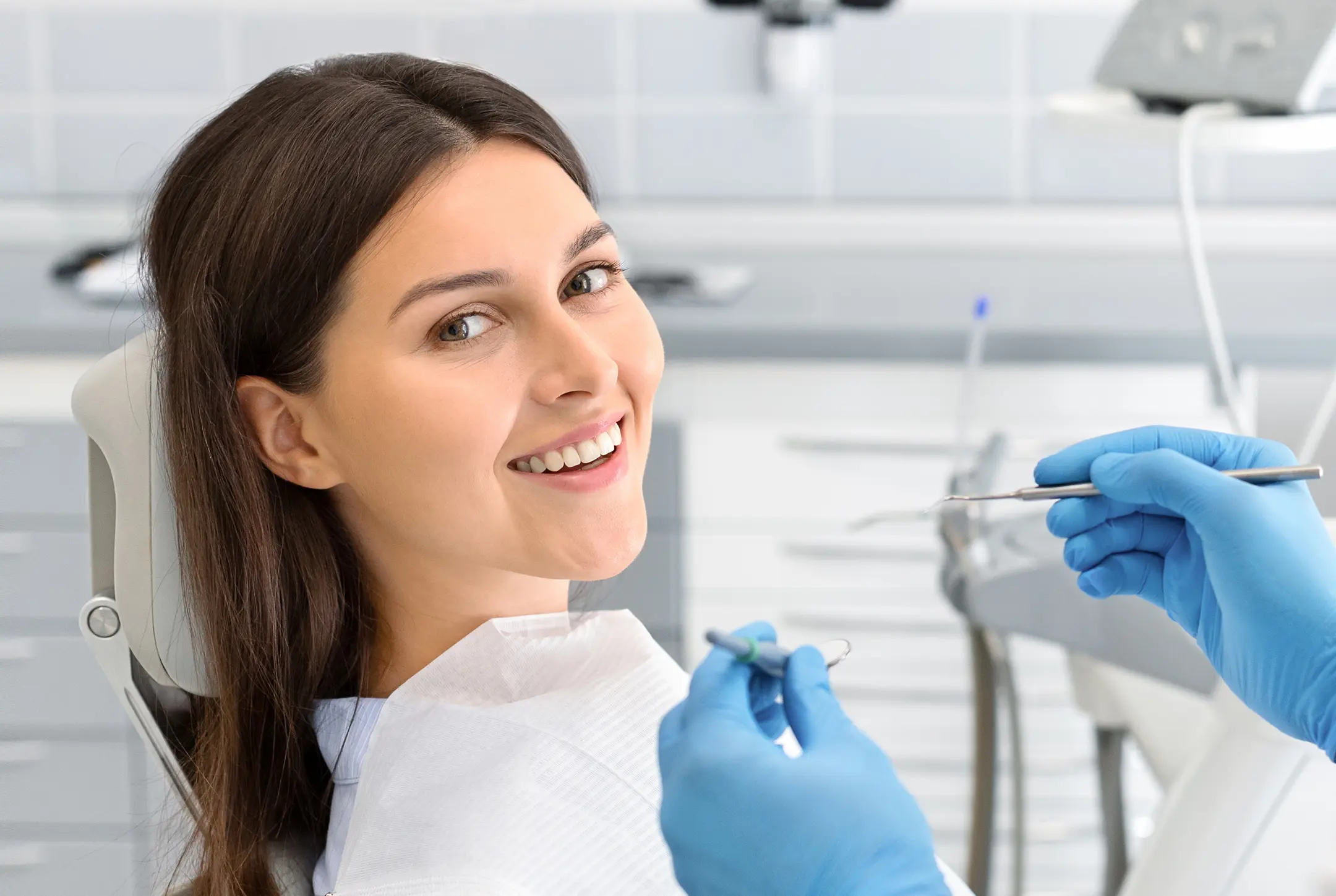 A woman in a dentist's chair getting her teeth checked.