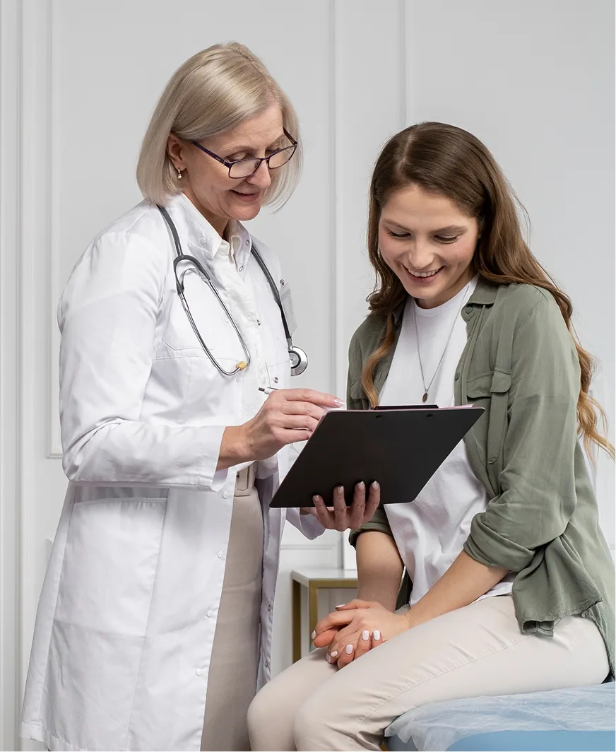 A female doctor and a female patient looking at a clipboard.