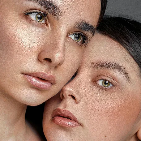 Two women are posing for a picture together.