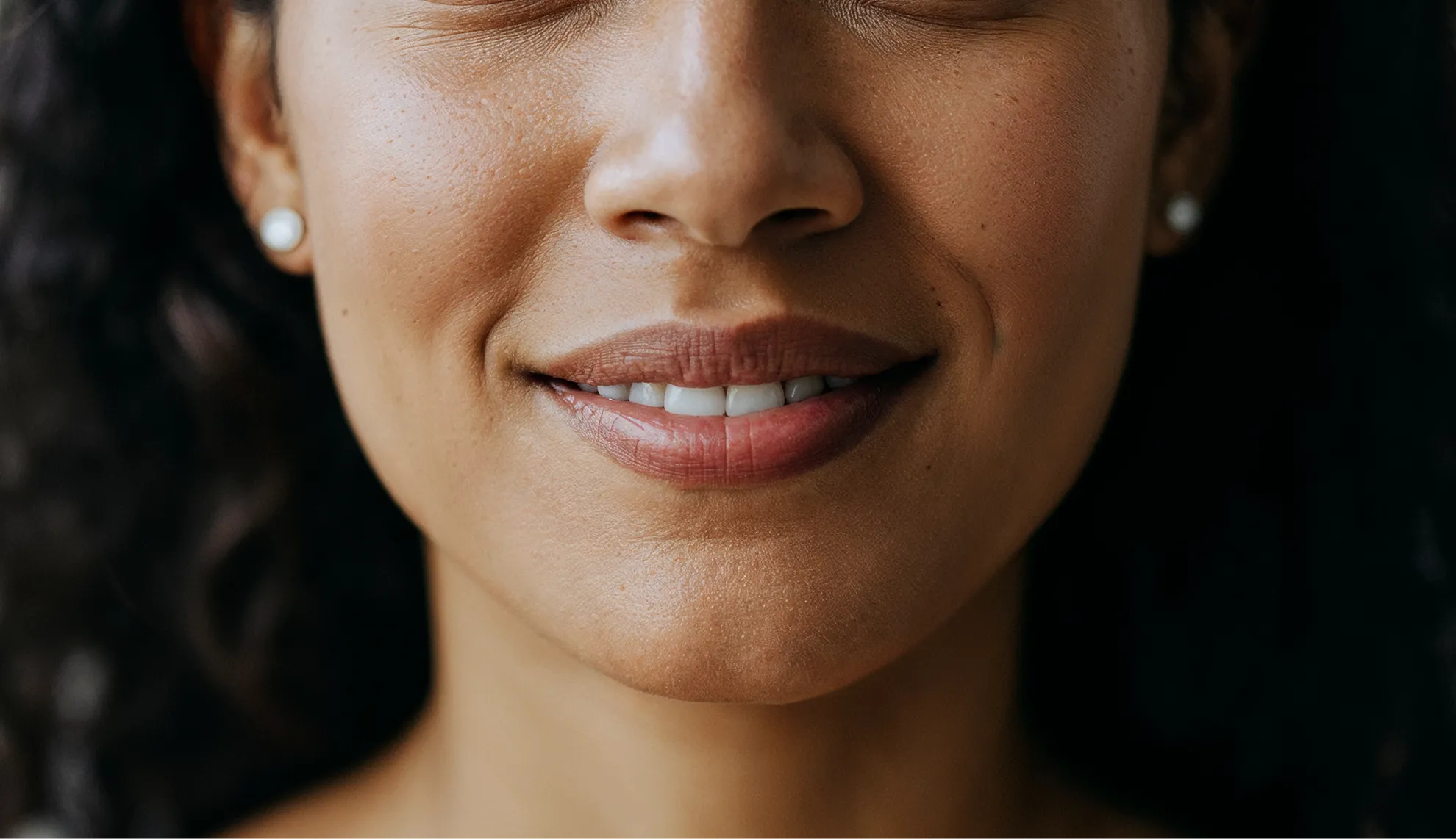 A close up of a woman with her eyes closed.