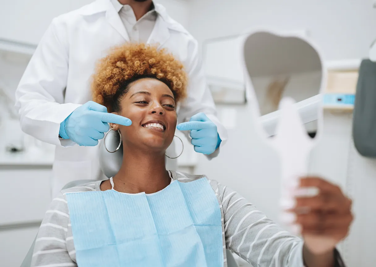 A woman getting her hair cut by a hair stylist.