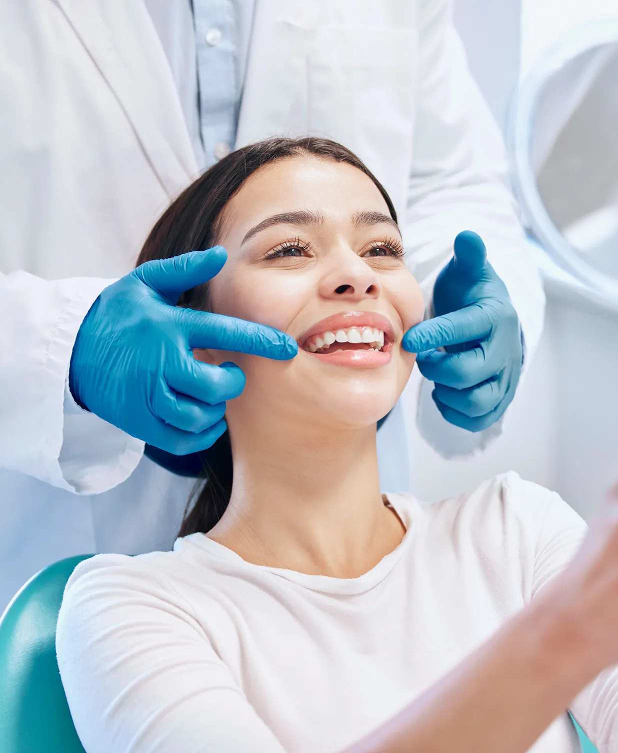 A woman getting her teeth checked by a dentist.