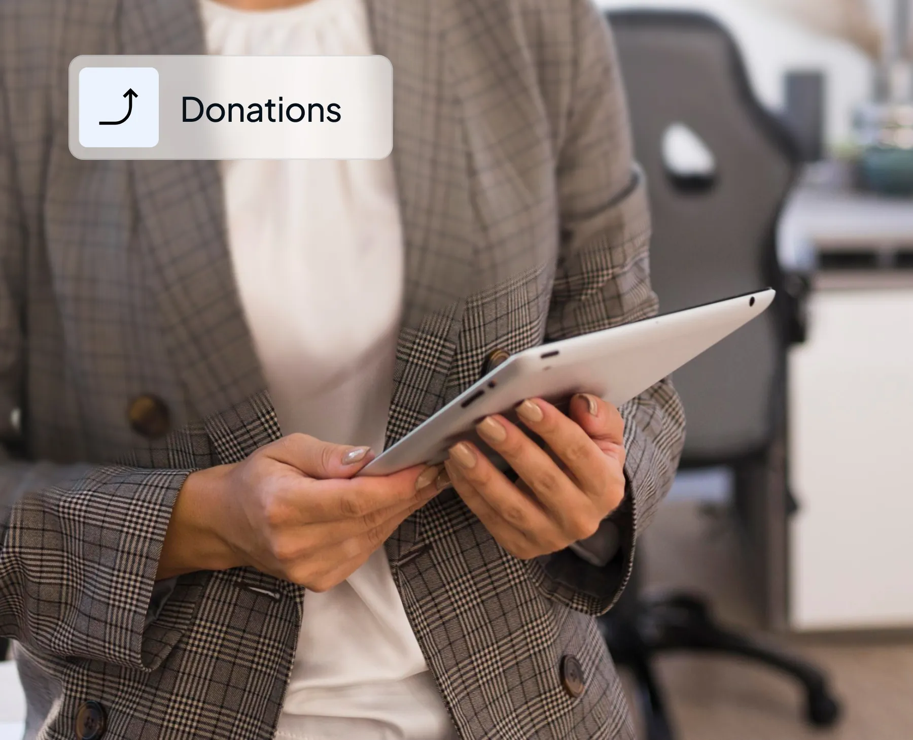 Person in a plaid blazer holding a tablet with a donations icon overlay.