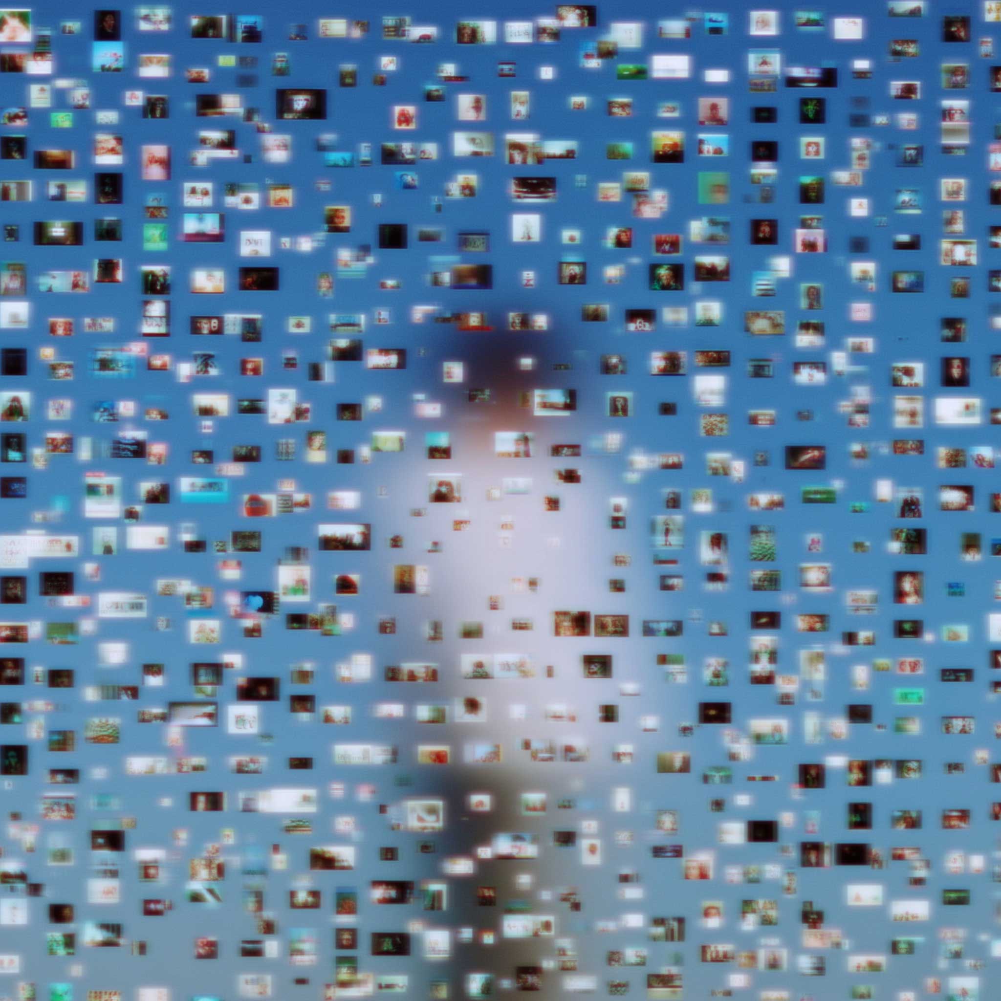 Blurry collage of hundreds of tiny digital photos forming a soft mosaic of a person against a blue background