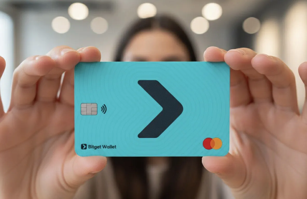 Person holding a turquoise Bitget Wallet Mastercard with a large black arrow symbol in the center.
