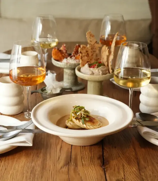 Dining table with plated dishes at Tatar Bunar