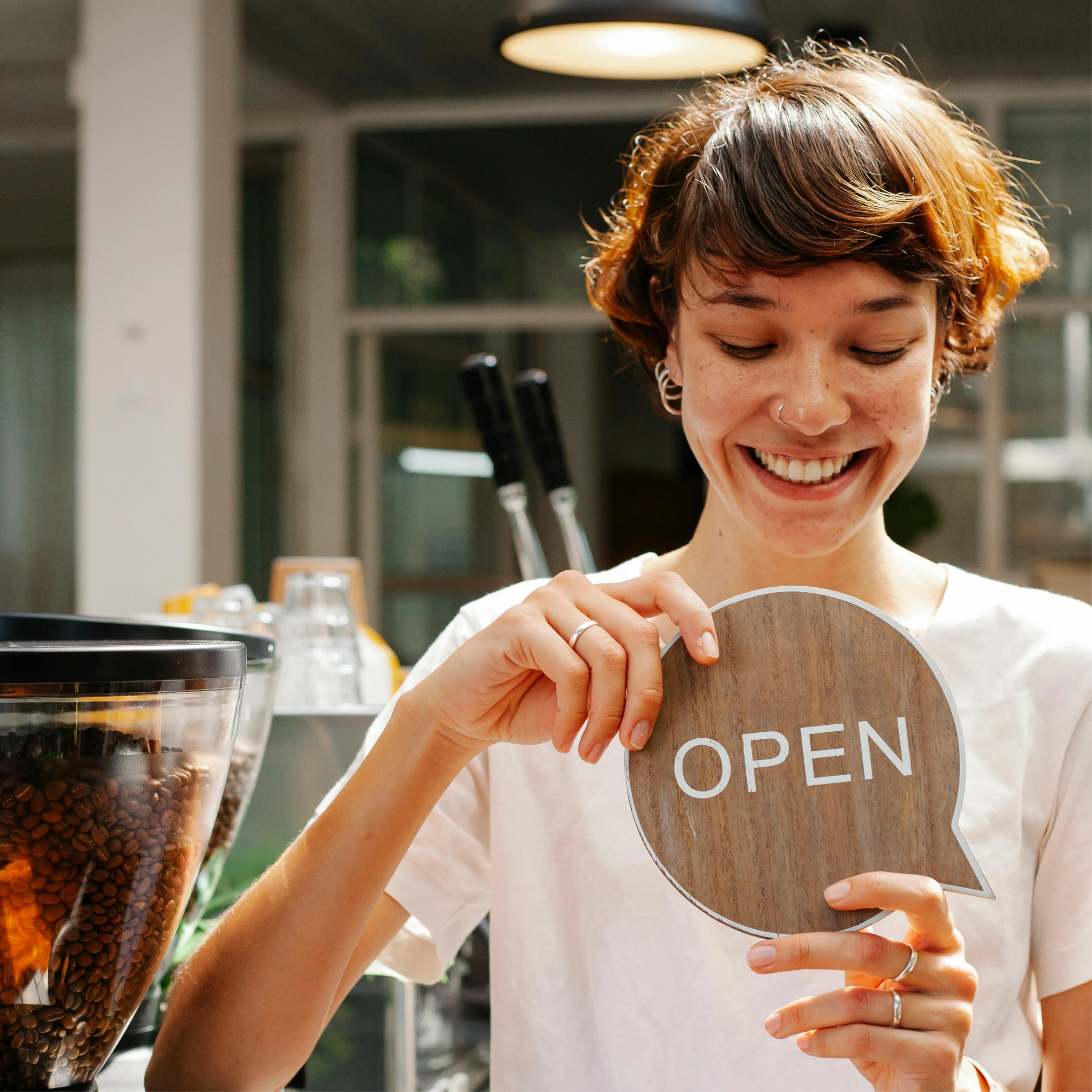 Image of happy business owner with an open sign