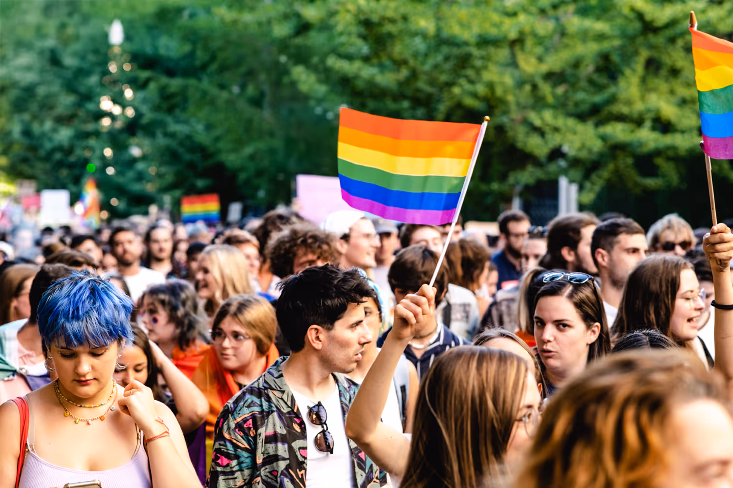 A image of a crowd at a LGBTQ+ pride parade.