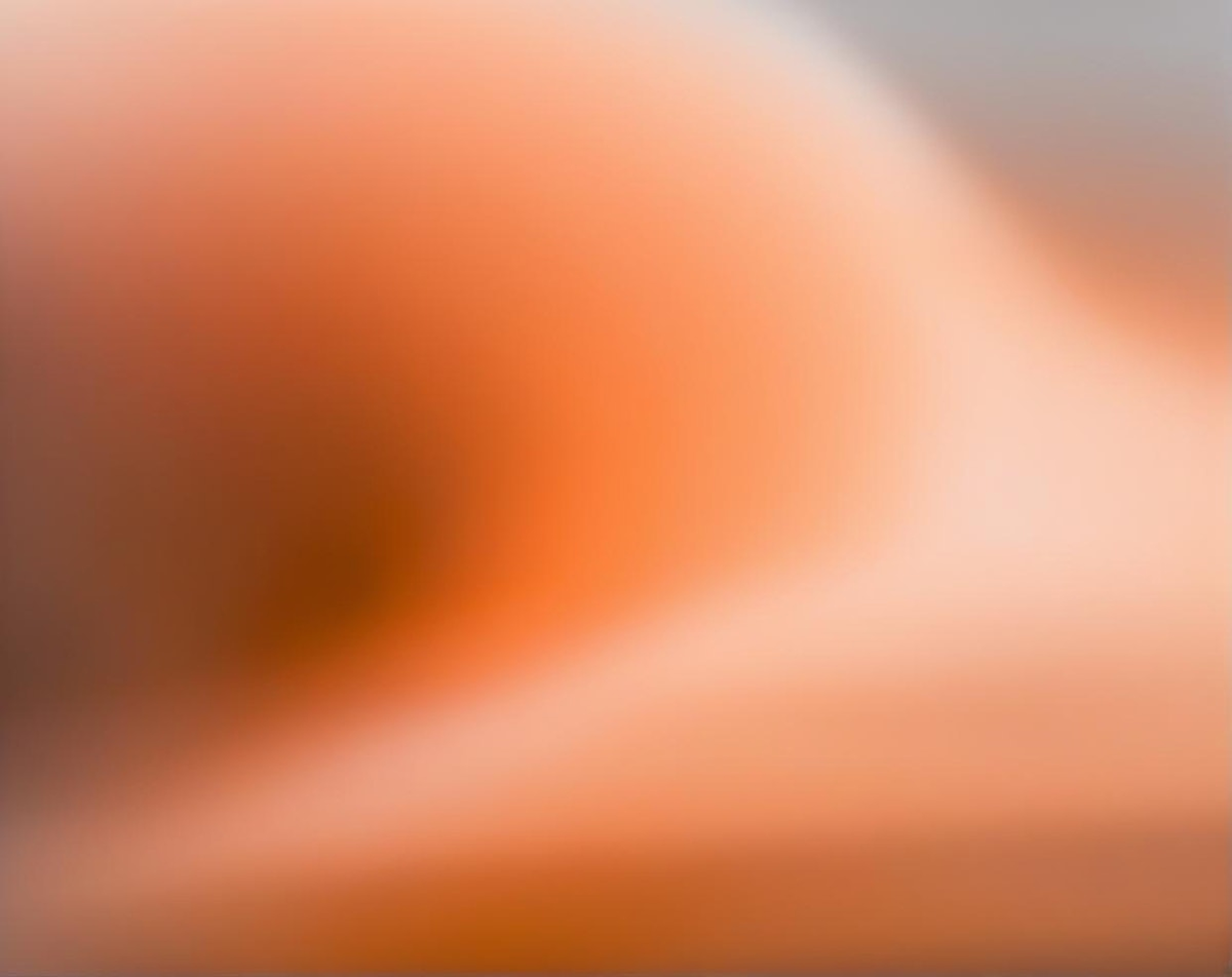 Abstract gradient background blending warm hues of orange, peach, and beige.