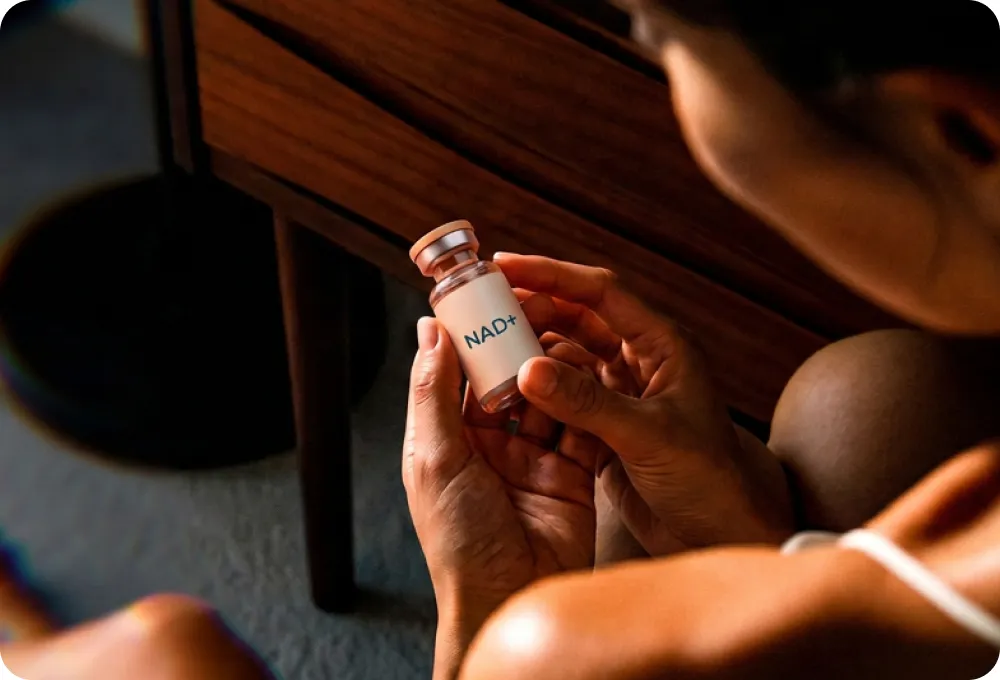 Provider holding a vial of NAD+