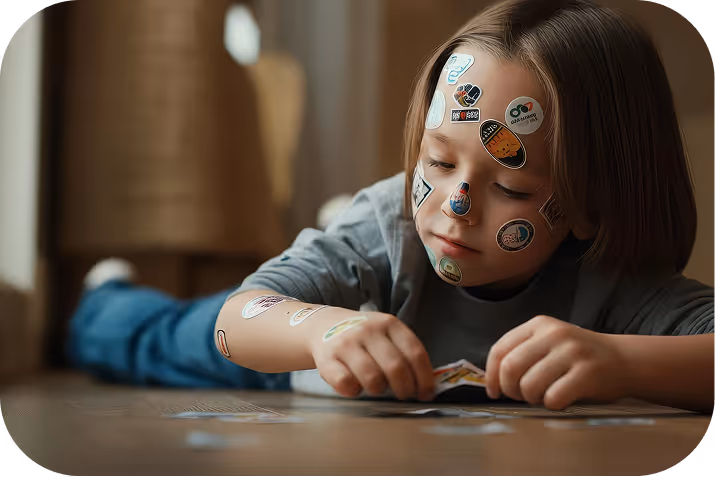 Little girl reading a large illustrated book in a dimly lit room, with warm light and holiday decorations behind her.