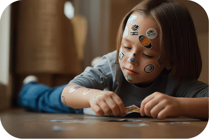 Little girl reading a large illustrated book in a dimly lit room, with warm light and holiday decorations behind her.