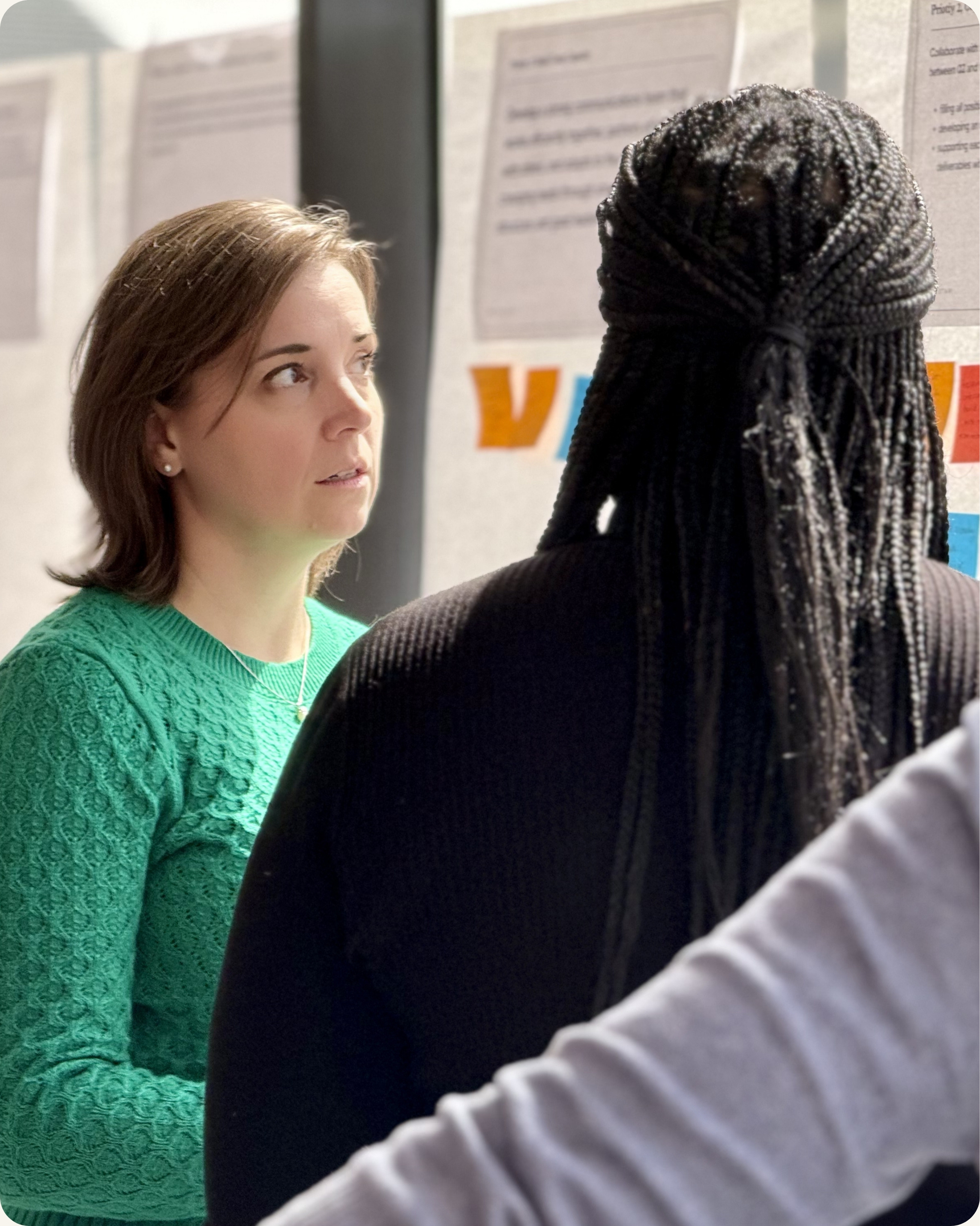 Two senior leaders in focused conversation during executive presence workshop — CoachVikram & Company Chicago