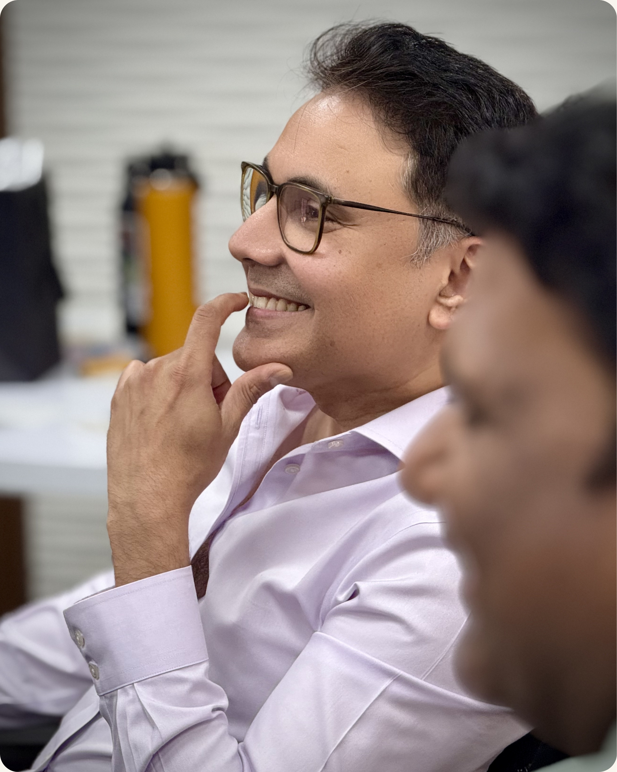 Senior leader smiling thoughtfully during executive presence workshop session — CoachVikram & Company Chicago
