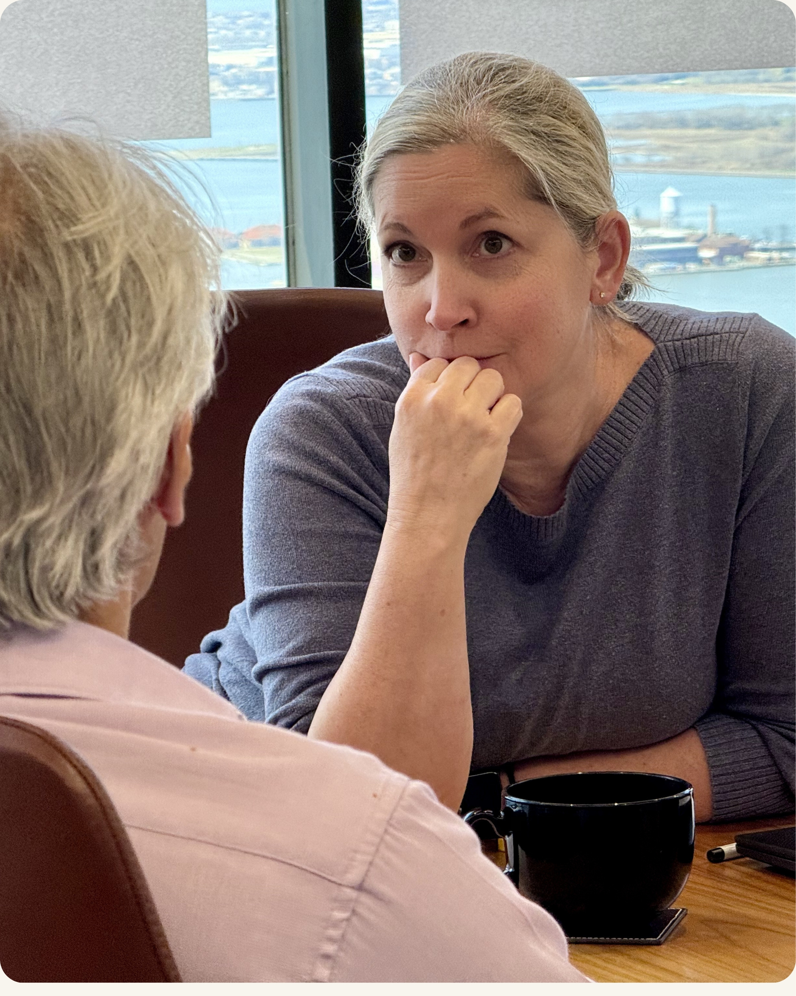 Senior leaders in focused conversation during executive presence coaching session in Seattle Washington — CoachVikram & Company