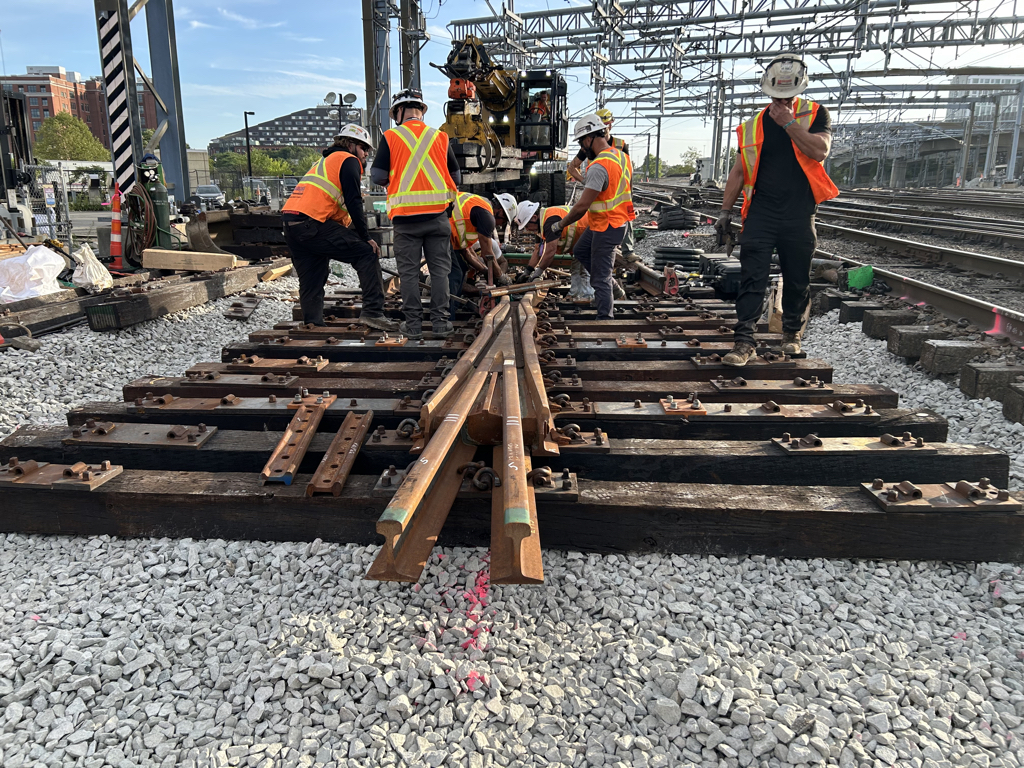 Crew laying pipe in an open trench