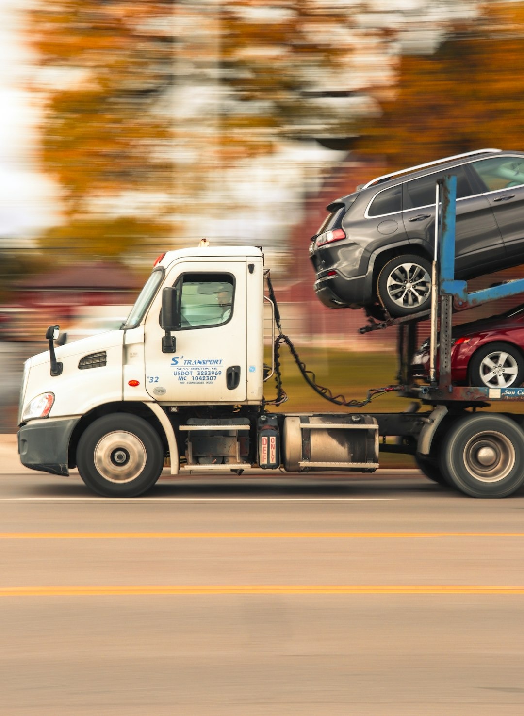 Car carrier truck transporting vehicles on a road