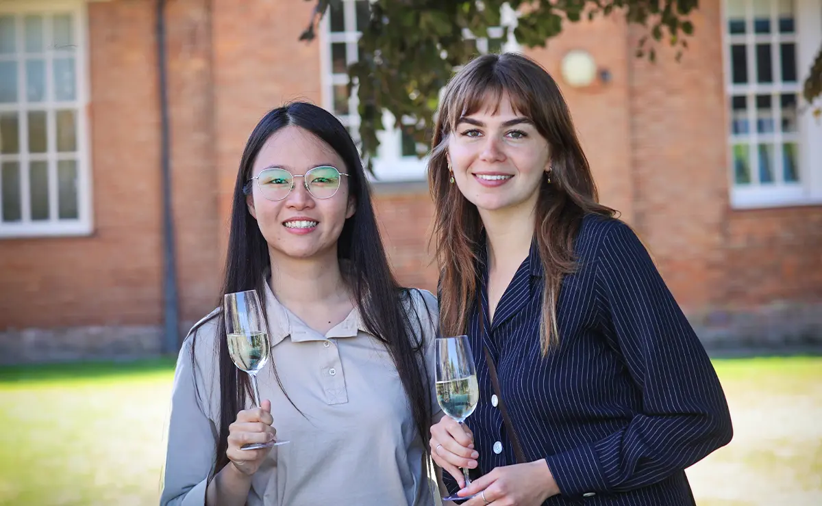 Two festivalgoers smile with champagne flutes at the JAM festival opening reception.
