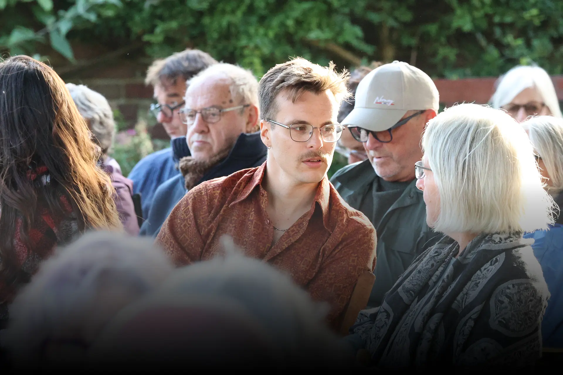 JAM Festival audience in animated conversation at the closing garden reception.