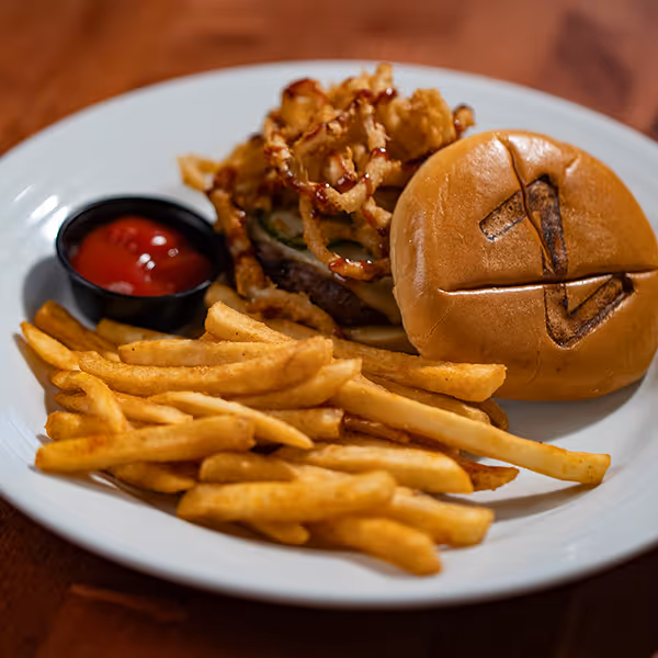 A handcrafted burger topped with crispy onions and fries served at Z’s Restaurant in Winnsboro, Texas. Enjoy bold flavors, fresh ingredients, and small-town hospitality at one of East Texas’s favorite dining spots.