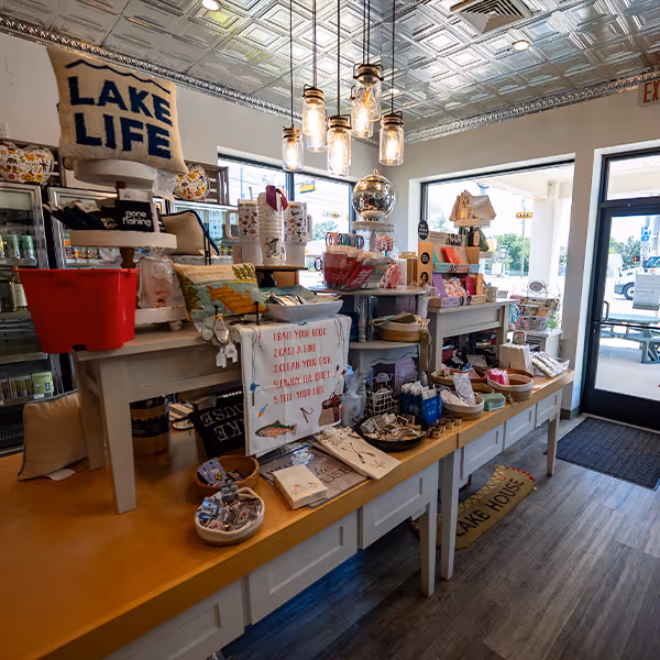 Display of unique local gifts, lake-themed décor, and handmade items at Sinclair Market in Winnsboro, Texas. Shop local and discover charming East Texas treasures perfect for home, friends, and family.