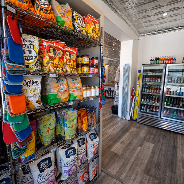 Colorful shelves of chips, popcorn, and specialty drinks at Sinclair Market in Winnsboro, Texas. Discover local favorites, artisanal snacks, and a taste of East Texas hospitality in this charming market café.