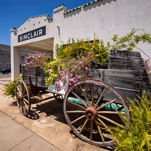 A rustic wagon filled with flowers sits outside Sinclair Market in downtown Winnsboro, Texas. This beloved local café and market blends small-town charm with fresh flavors, gifts, and East Texas hospitality.