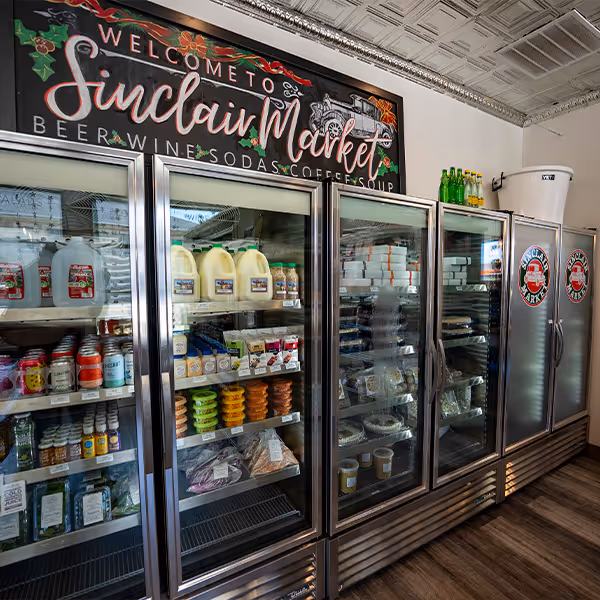 Refrigerated section at Sinclair Market in Winnsboro, Texas, stocked with local dairy, fresh produce, and handmade foods. A go-to spot for quality East Texas products, from milk and cheese to coffee and soups.