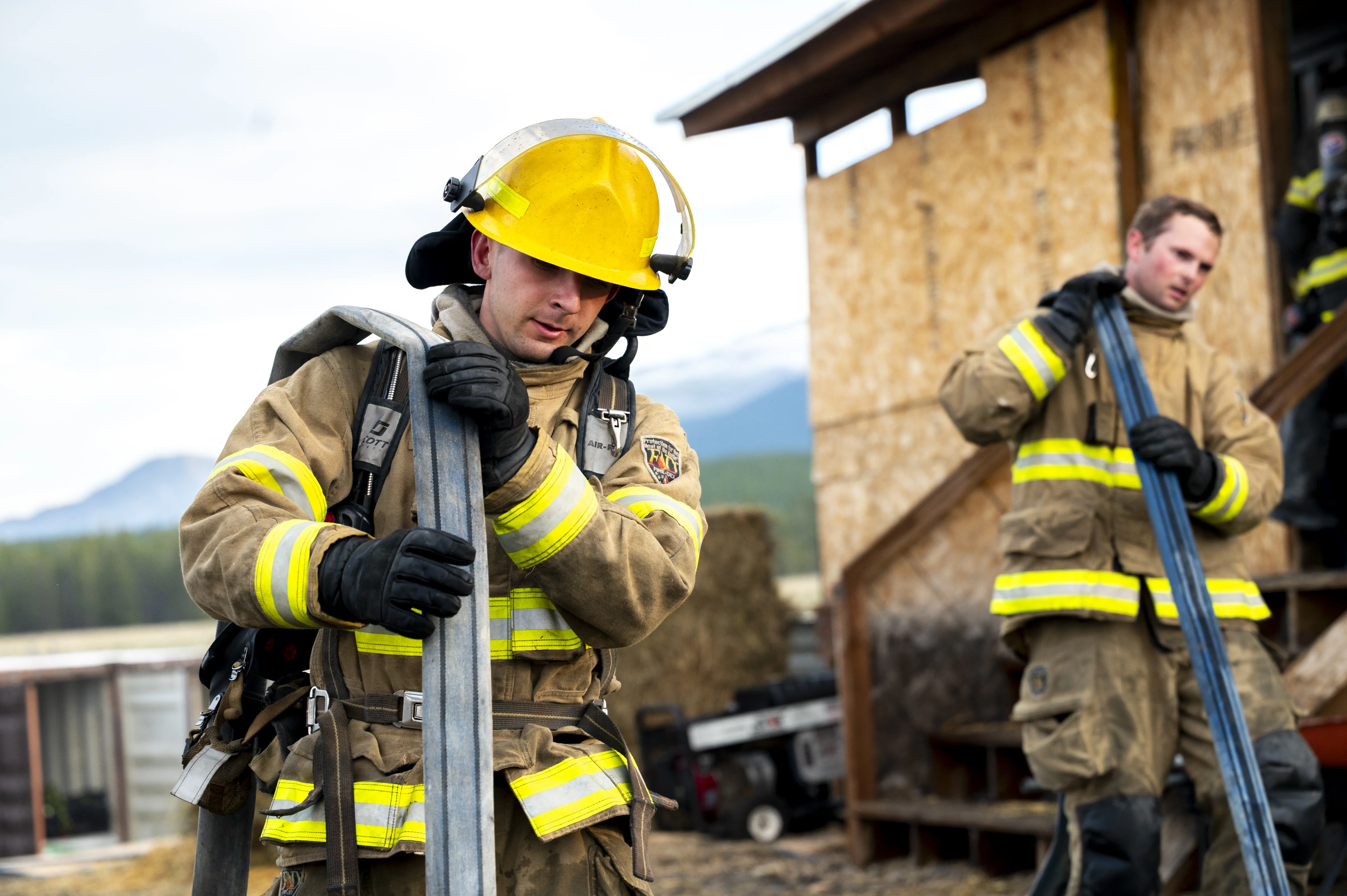 firefighting students holding fire hose