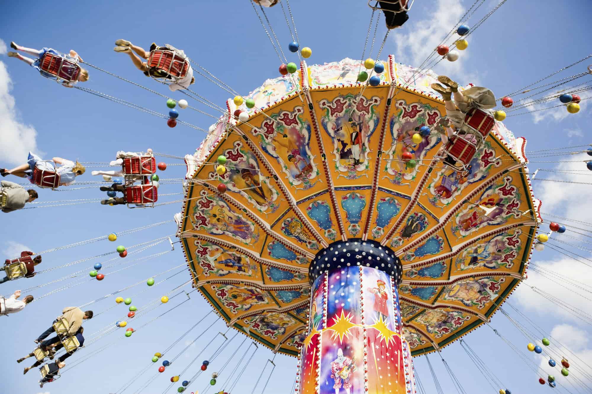 people riding on carnival swing ride