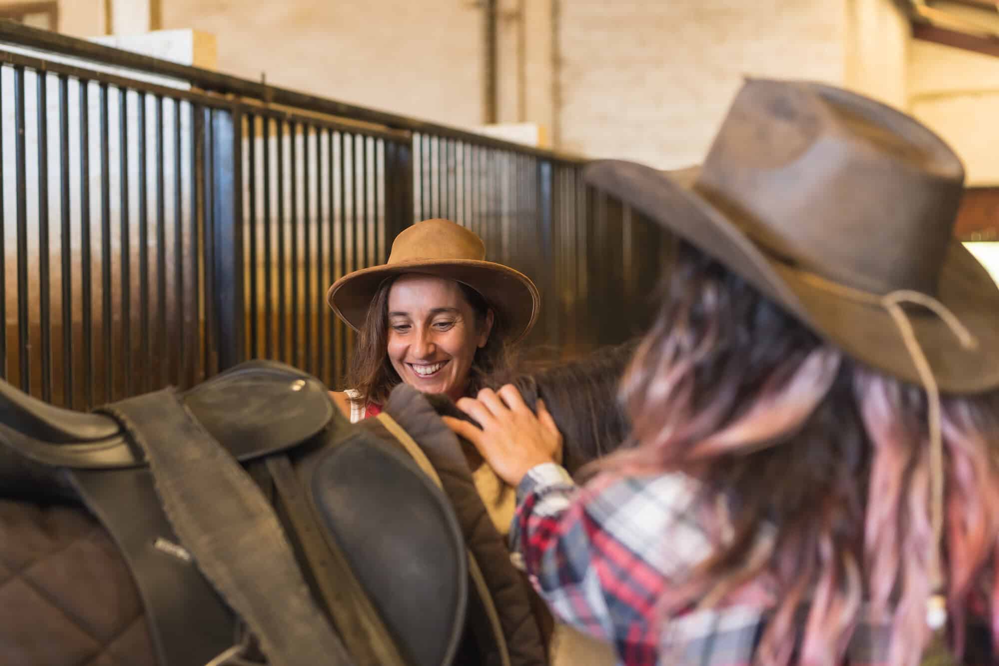 two cowgirls working with a horse
