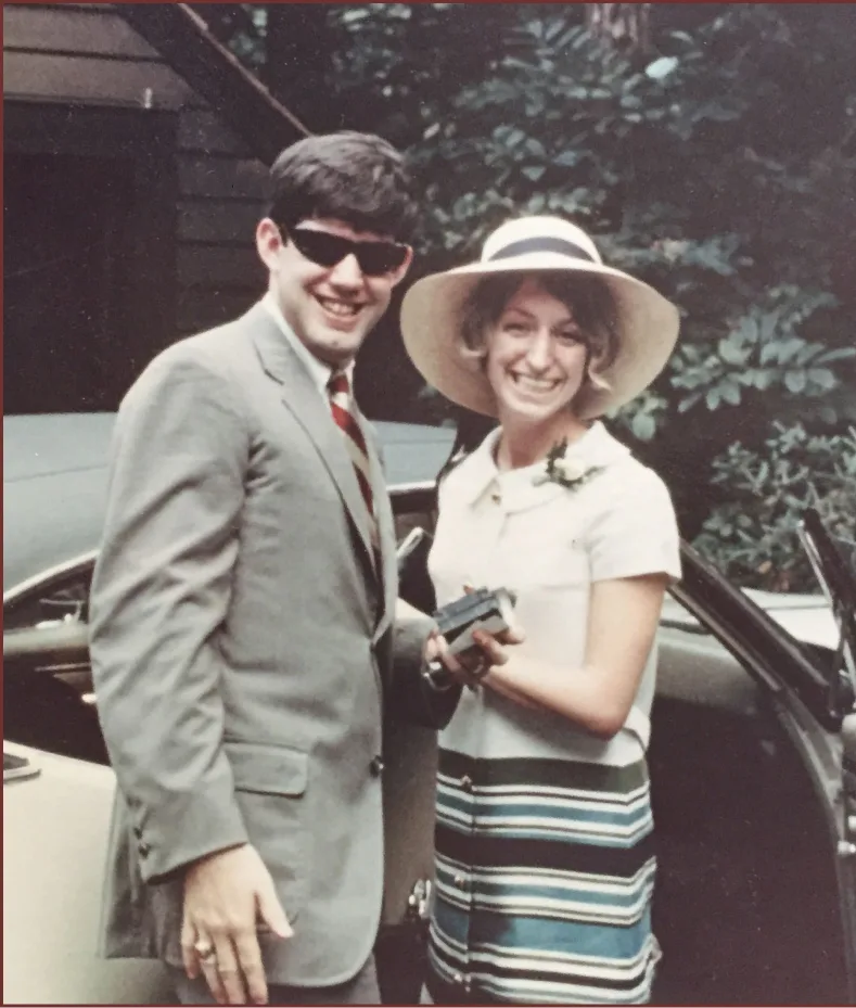 Young couple smiling together in a vintage family photo.