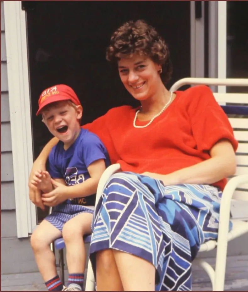  Mother and young son laughing together on a summer porch