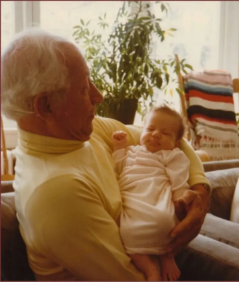 Grandfather holding his newborn grandchild, a family moment worth protecting as loved ones age