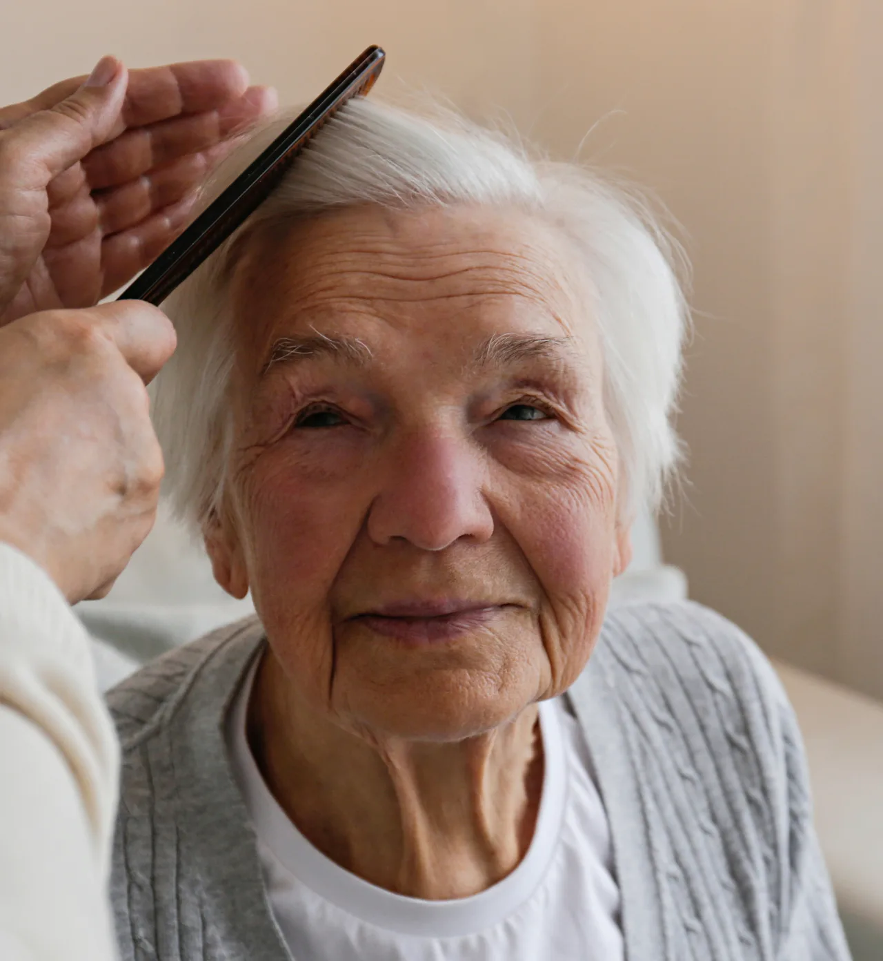 Senior living resident receiving personal care and daily support from a caregiver