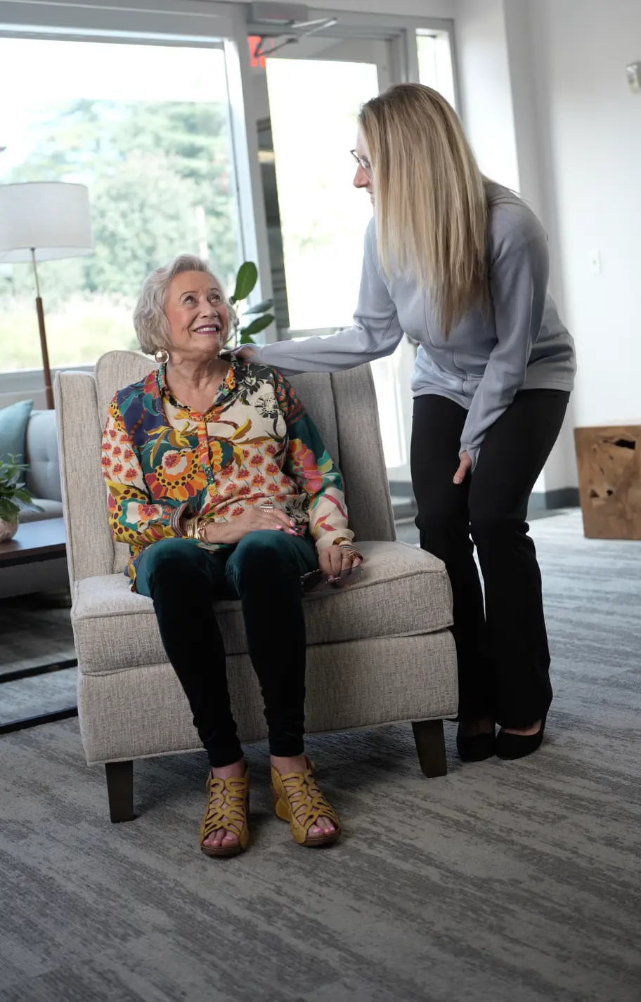 Alder life care manager smiling and holding a notebook, ready to help families navigate senior care