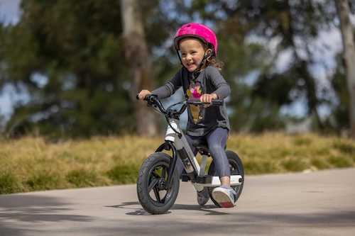 A young child on a balance bike