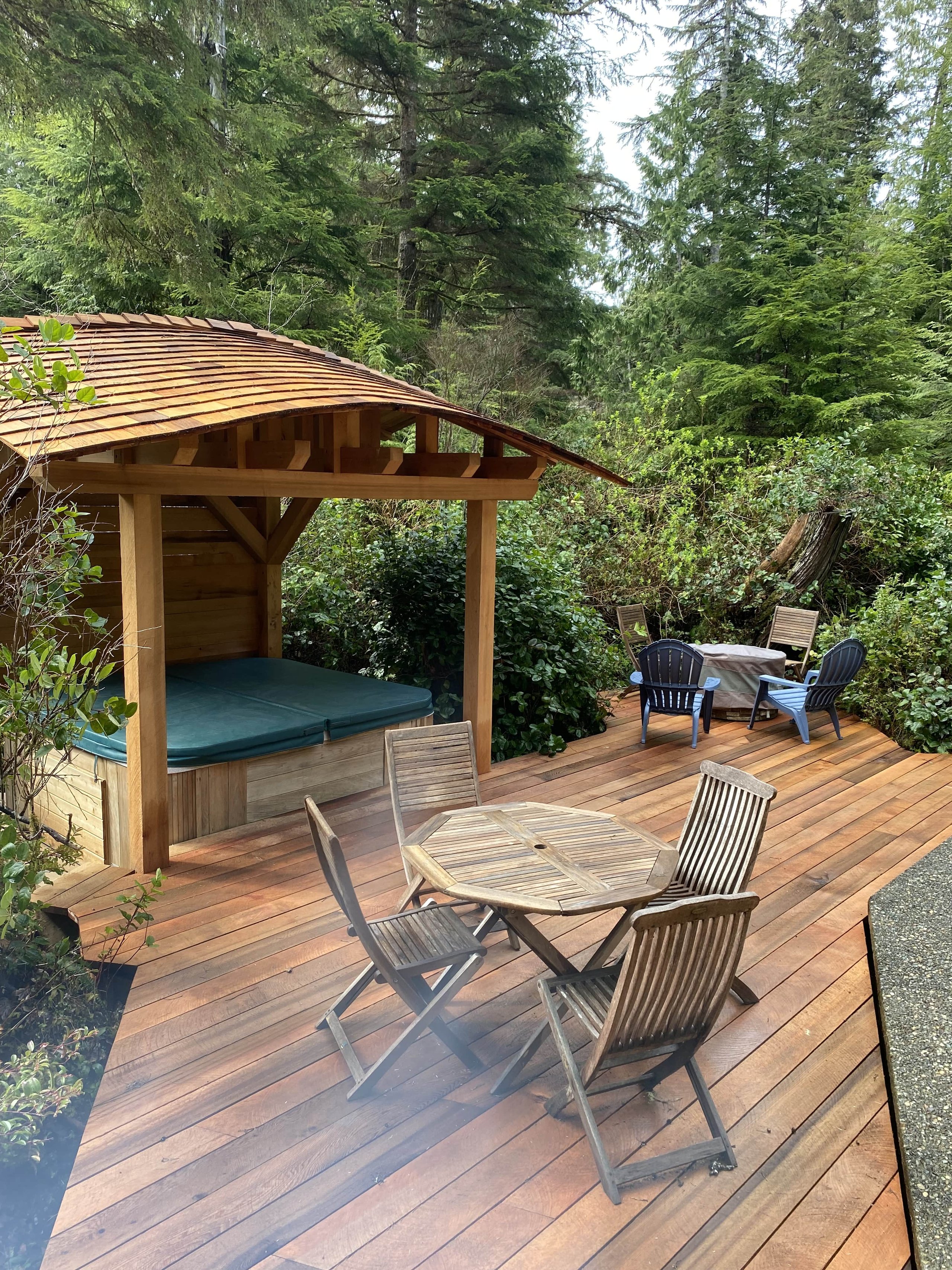 Custom cedar deck with hot tub and curved wood canopy