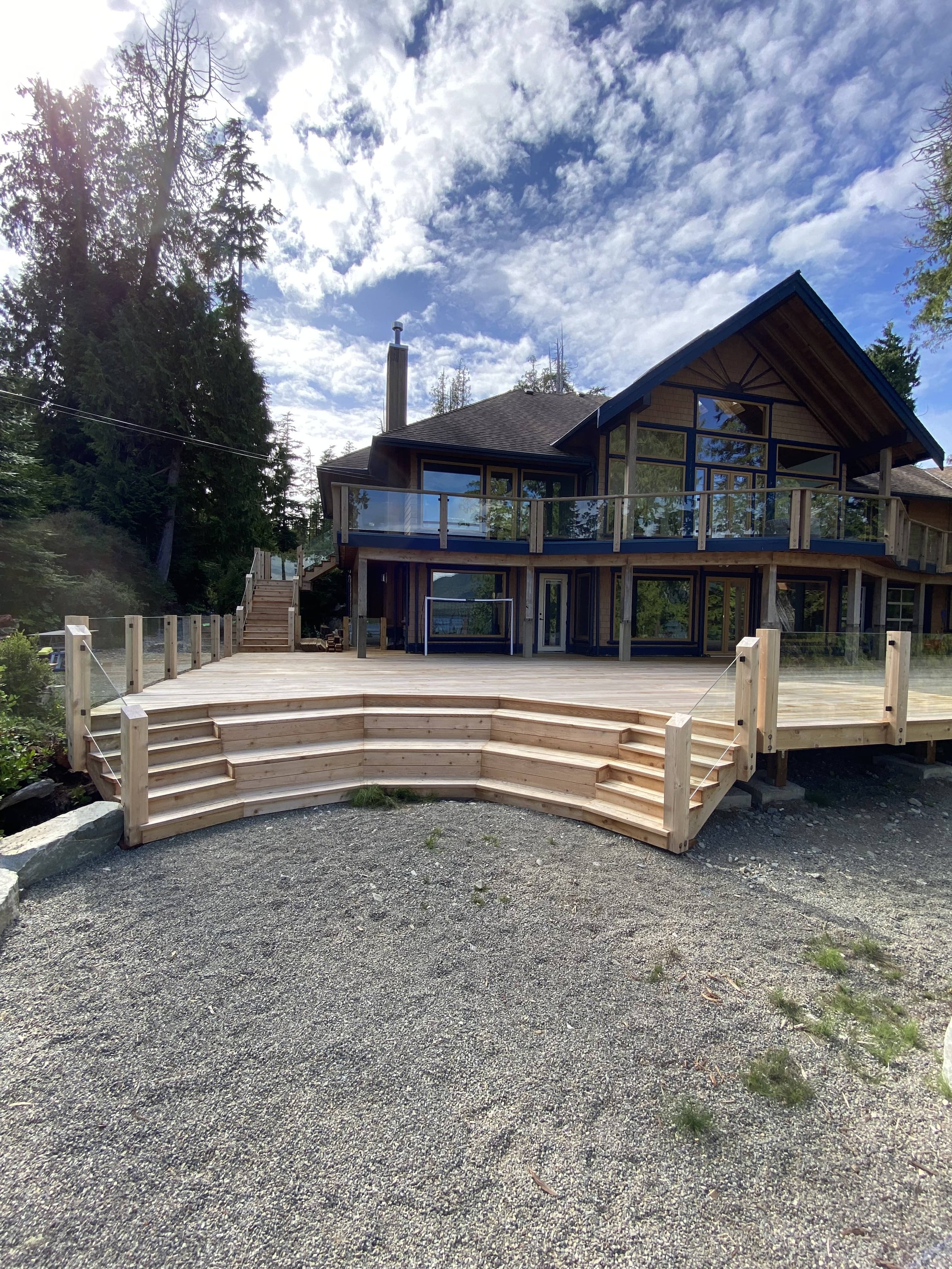 Curved stairs to large custom deck. Made of cedar