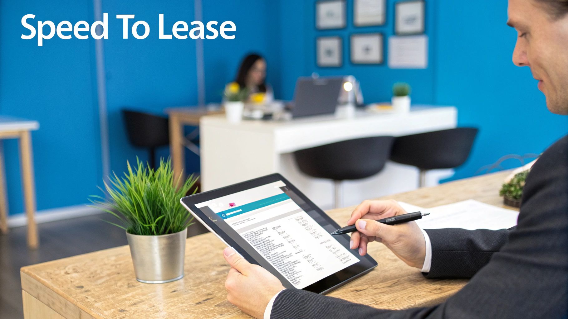 A person filling out an online rental application on a laptop, with a modern apartment building in the background.